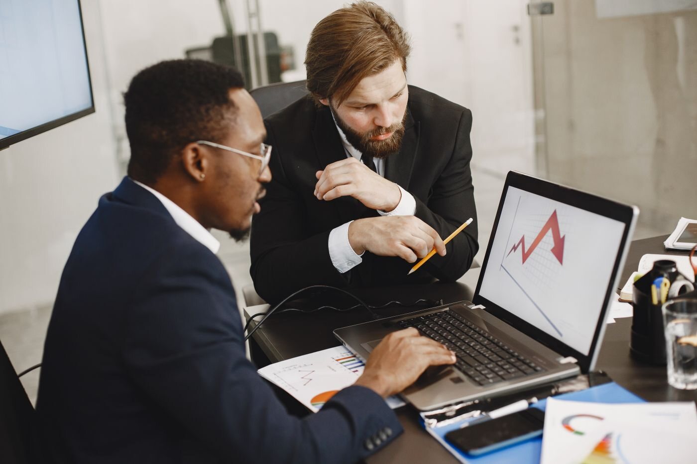 Sales professionals collaborating around CRM and website visitor data
